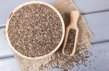 Chia seeds on wooden background. A component of a healthy diet.