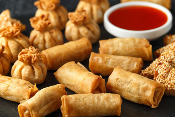 Crispy Chicken wontons, vegetable spring rolls and prawn toasts with sweet chilli sauce. chinese selection. fast food.