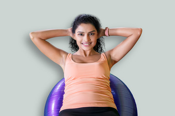 Wall Mural - Beautiful woman exercises with a fitness ball