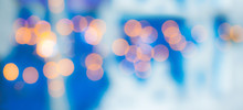 Bright Orange Bokeh On A Blue Background. Festive Abstract Background_