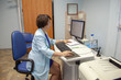 © Ольга Кирюхина - doctor in blue coat sitting at the computer