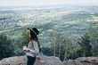 © Yura Yarema - Beautiful girl in the hat drinks coffee on top of the mountain. Concept adventure active vacations outdoor in the mountains. Summer camp