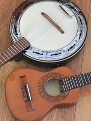 Close-up of two Brazilian musical instruments: cavaquinho and samba banjo on a wooden surface. They are widely used to accompany samba, the most famous Brazilian rhythm.