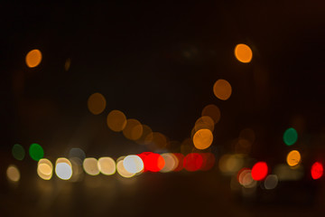 Wall Mural - Artistic style - Defocused urban abstract texture ,blurred background with bokeh of city lights from car on street at night, vintage or retro color tone