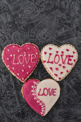 Valentine's Day Cookies. Baking in the form of a heart on a gray background. Pink sweet products. Top view