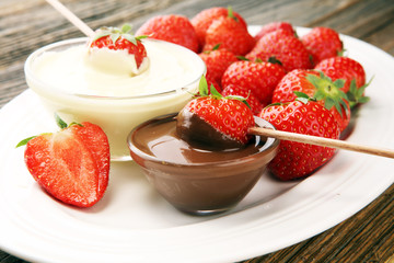 Wall Mural - Fondue with Melting chocolate or melted chocolate and strawberry.