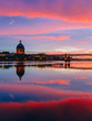 Sunset over Garonne River, with reflections of Saint-Pierre Bridge and Chapel of hôpital Saint-Joseph de la Grave, in Toulouse, France