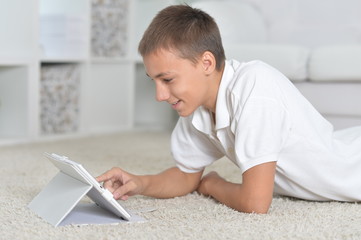 Poster - Portrait of a young boy with the tablet