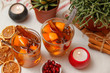 © Milan - Romantic composition with two cups of tea with orange, anise and cinnamon. On table also candles, cactus, dried orange and cinnamon sticks.