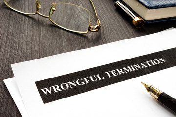 Wall Mural - Documents about Wrongful termination on a wooden desk.