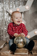© alexkoral - Happy little boy smiling in the red shirt on the background of Christmas decorations
