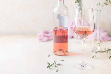 Wall Mural - Glass and bottle of rose wine on light background.