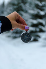 The compass in the hands during the winter travel