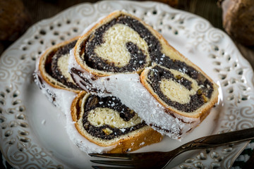 Two pieces of poppie-seed cake on a plate.