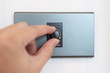 © marchsirawit - Close up hand turning on grey dimmer switch