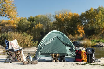 set of equipment near camping tent outdoors