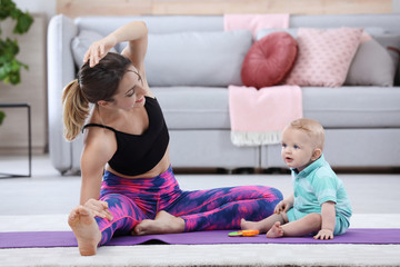 Sticker - Young sportive woman doing exercise with her son at home. Fitness training