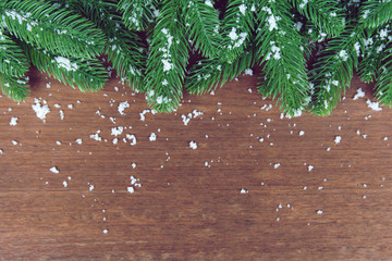 Wall Mural - Christmas background. Fir tree branches and with snow decoration on a wooden board. with copy space for text.