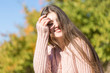 © Mountains Hunter - Portrait of pretty young woman in stylish knitted sweater standing on the golden autumn forest on sunny day