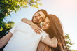 © teksomolika - Young couple walking in the summer park.