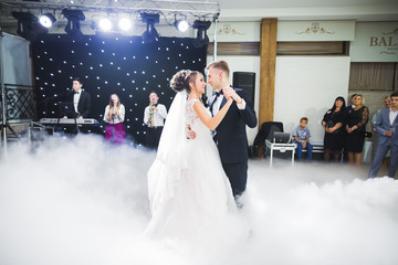 Beautiful wedding couple just married and dancing their first dance