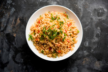 Schezwan Fried Rice Masala Is A Popular Indo-chinese Food Served In A Plate Or Bowl With Chopsticks. Selective Focus