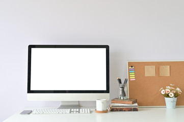 workspace with mockup laptop computer on office table and office supplies.