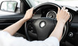 © Prostock-studio - Woman driving car with hands on steering wheel