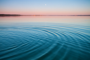 The turquoise lake at dawn.small symmetrical waves