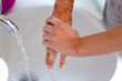 © michaelheim - Woman washing her hands under running water