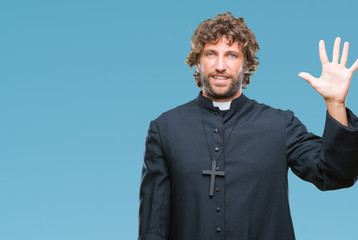 Wall Mural - Handsome hispanic catholic priest man over isolated background showing and pointing up with fingers number five while smiling confident and happy.