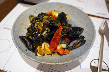 Wall Mural - Dish of fresh pasta with seafood and shellfish in Italy