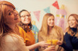 © Kitja - Pregnant woman celebrating baby shower party with friends.