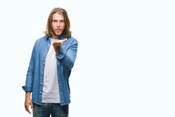 Poster - Young handsome man with long hair over isolated background looking at the camera blowing a kiss with hand on air being lovely and sexy. Love expression.