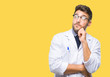© Krakenimages.com - Young handsome man wearing doctor, scientis coat over isolated background with hand on chin thinking about question, pensive expression. Smiling with thoughtful face. Doubt concept.