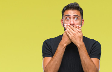 Canvas Print - Adult hispanic man over isolated background shocked covering mouth with hands for mistake. Secret concept.