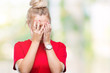 © Krakenimages.com - Young blonde woman wearing glasses over isolated background with sad expression covering face with hands while crying. Depression concept.