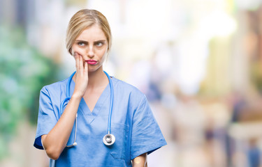 Poster - Young beautiful blonde doctor surgeon nurse woman over isolated background thinking looking tired and bored with depression problems with crossed arms.