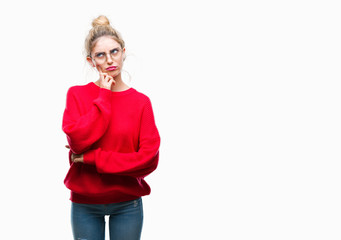 Sticker - Young beautiful blonde woman wearing red sweater and glasses over isolated background with hand on chin thinking about question, pensive expression. Smiling with thoughtful face. Doubt concept.