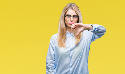 Canvas Print - Young beautiful blonde business woman wearing glasses over isolated background looking unhappy and angry showing rejection and negative with thumbs down gesture. Bad expression.