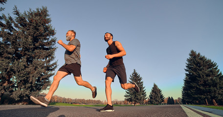 Wall Mural - The two sportsmen running on the alley