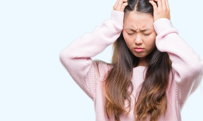 Sticker - Young asian woman over isolated background suffering from headache desperate and stressed because pain and migraine. Hands on head.