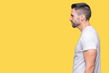 Young man wearing casual white t-shirt over isolated background looking to side, relax profile pose with natural face with confident smile.