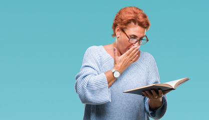 Canvas Print - Senior caucasian woman reading a book over isolated background cover mouth with hand shocked with shame for mistake, expression of fear, scared in silence, secret concept