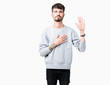 © Krakenimages.com - Young handsome man wearing sweatshirt over isolated background Swearing with hand on chest and open palm, making a loyalty promise oath