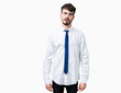 © Krakenimages.com - Young handsome business man wearing glasses over isolated background In shock face, looking skeptical and sarcastic, surprised with open mouth