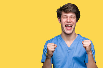 Young doctor wearing medical uniform over isolated background celebrating surprised and amazed for success with arms raised and open eyes. Winner concept.
