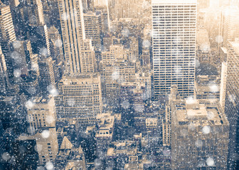 Wall Mural - New York City Manhattan skyscraper buildings with snowflakes falling during winter snow storm