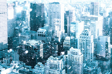 Wall Mural - New York City Manhattan skyscraper buildings with snowflakes falling during winter snow storm