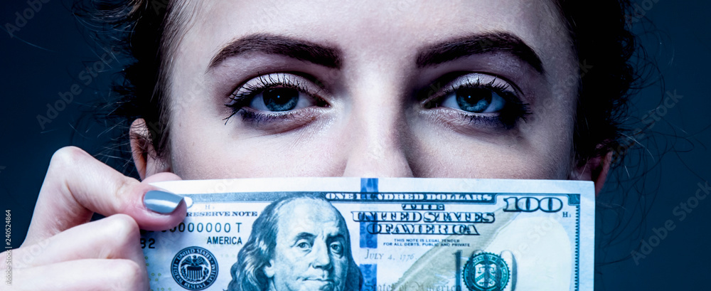 Woman covering her mouth with a dollar banknote as symbol of bribery ...